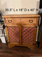 Front view of the solid wood cabinet showing drawer, lattice doors, dimensions overlaid