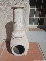 Whitewashed terracotta chimenea overall view