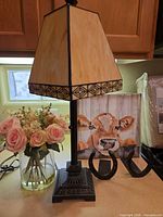Lamp, bookends, and canvas art grouped on countertop