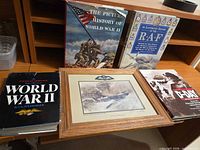 All four books with framed print on desk