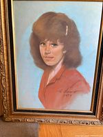 Front view of signed pastel portrait in ornate frame