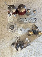 All eight salt and pepper shaker sets arranged on surface