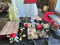 Group shot of all items on table including ornaments box, signs, figurines, votives