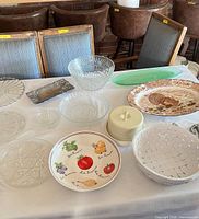 Wide view of all items on table showing glass, ceramic, metal pieces