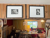 Framed black & white floral print hanging with matching print alongside