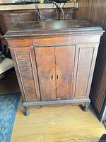 Front view of closed cabinet showing diamond inlay and hardware
