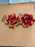 Front view of both porcelain rose plaques showing color, shape and gold trim