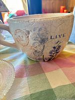 Side view showing crackle glaze, floral decal and handle