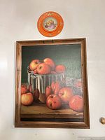 Overall view of framed painting and decorative plate on wall