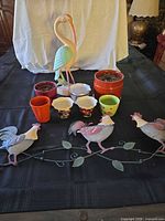 full lot overview with metal rooster vine, flamingo statue and planters
