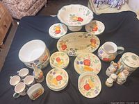 All dinnerware pieces laid out on black cloth