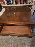 Top view showing wood grain, open drawer with Heritage stamp and metal pull