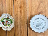 Front views of both decorative plates showing designs and gilt rims