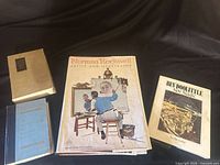 Group shot of four large-format hardcover books