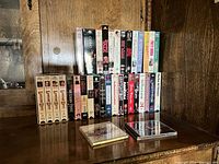 Full group of sealed VHS tapes on shelf showing two rows
