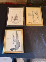 Overview of three framed prints on table