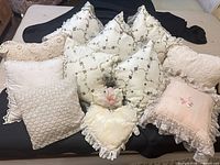 Full group shot showing all nine pillows and relative sizes, colors and styles