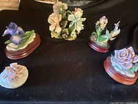 Group shot showing all five porcelain figurines with bases