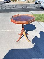 Full view of octagonal pedestal side table on driveway