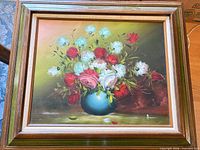 Front view of framed oil painting showing floral subject