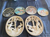 Overview showing both off-white oval plaster plaques