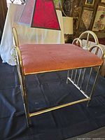 Overall view of brass vanity bench with pink velvet seat