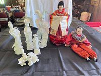 Group shot of all dolls and figurines on table