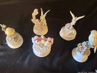 Group shot of five porcelain bird music box figurines