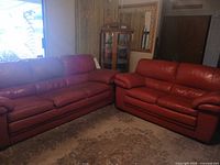 Both red leather sofa and loveseat in room