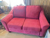 Front view of red microfiber loveseat showing cushions and overall design