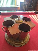 Top view showing four cylindrical compartments and central lidded section