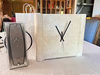 Both clocks side by side on table