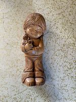 Front view bronze-tone girl figurine