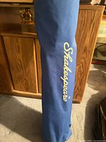 Blue Shakespeare-branded carry bag upright
