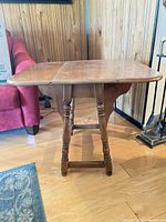 Full view of drop-leaf table open, showing top surface and legs