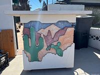 Front view showing desert motif relief and stucco finish