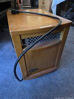 Front and side view of SunHeat wood cabinet heater with power cord