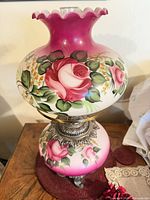 Front view showing painted rose design and metal base