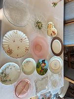 Group shot showing all porcelain and glass plates arranged on table