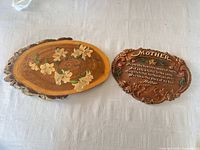 Both wall plaques side by side on table surface