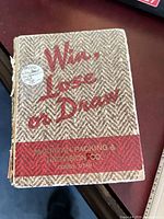 Close-up of pocket booklet "Win, Lose or Draw"