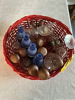 Top view showing mixed glassware inside red wicker basket