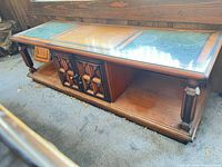 Full view of coffee table showing top green panels, cabinet doors and shelf