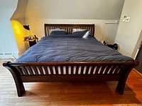 Full view of assembled king sleigh bed frame showing headboard, footboard and side rails