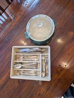 overall view of stockpot with lid and cutlery tray filled with flatware