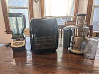 Three appliances side by side: blender, air fryer, juicer