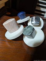 All four stone drawer knobs top view on wooden surface