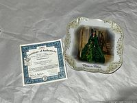 Plate and certificate displayed on tissue paper