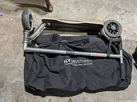 Scooter folded on top of NYCeWheels bag