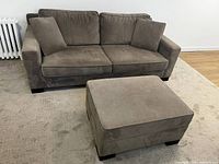 Front view of sofa and ottoman showing overall style and colour